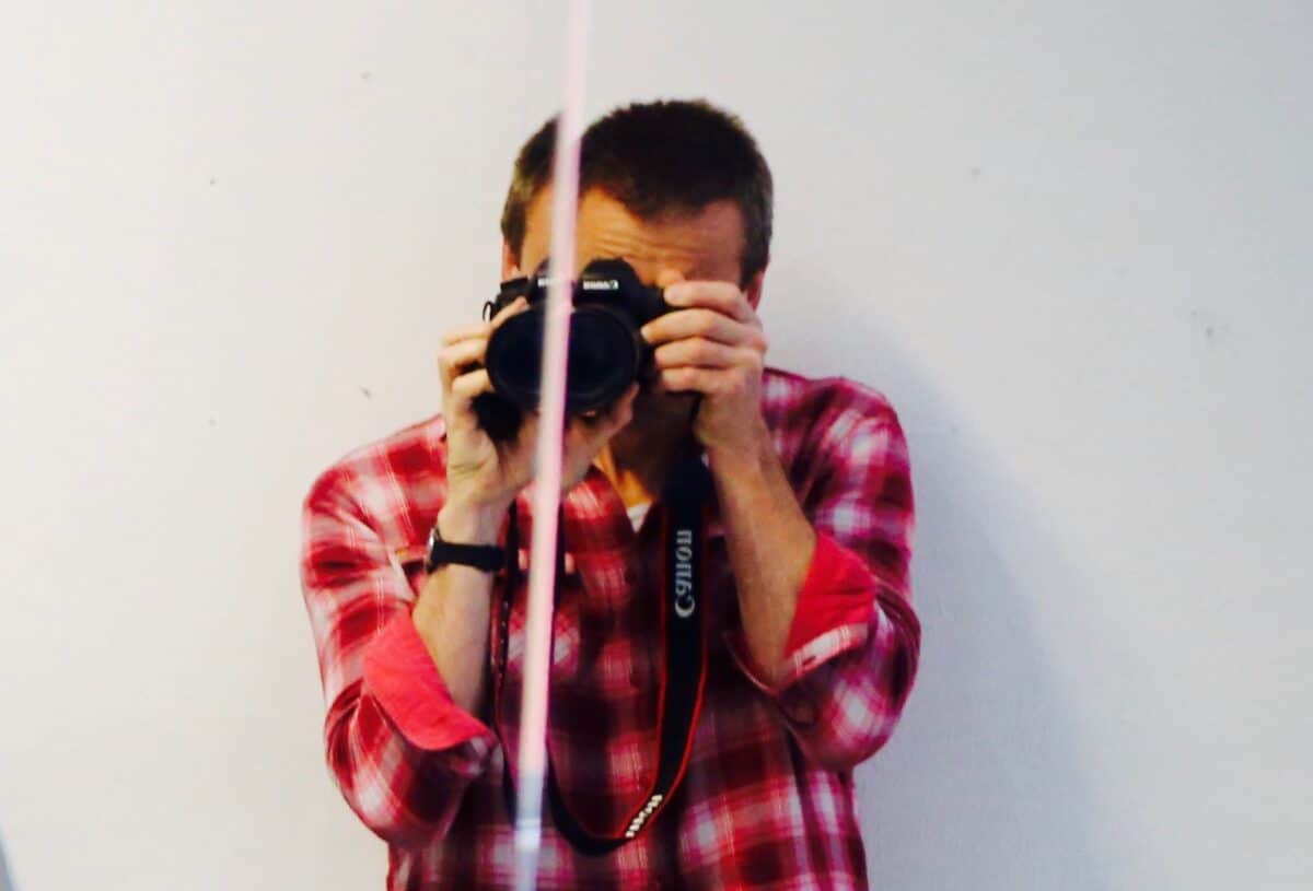 Alan Gilsenan holding a camera